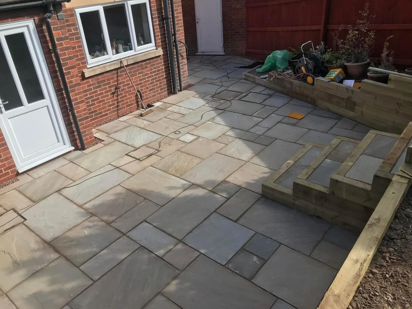 Paved seating area beside the house
